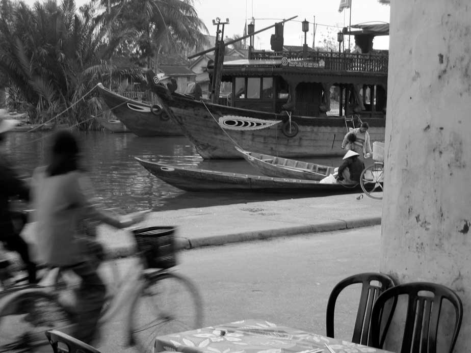 Biker and boats in Hoi An, Vietnam